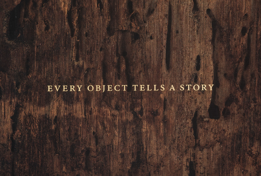Every object tells a story in a serif typeface on top of an image of weathered wood