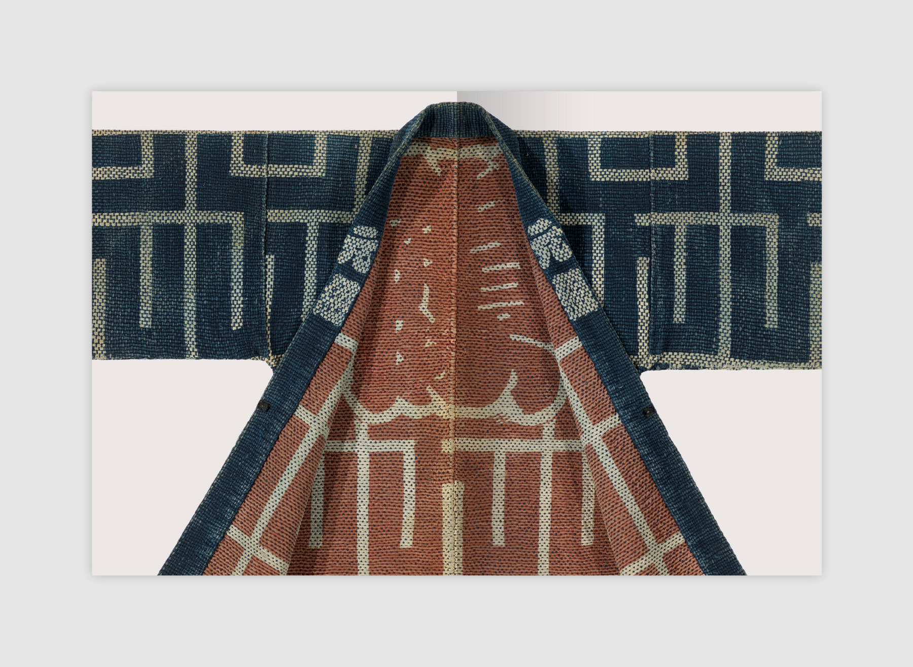 Textiles of Japan book spread showing a detail of a fireman's coat in heavy quilted cotton with resist-patterning