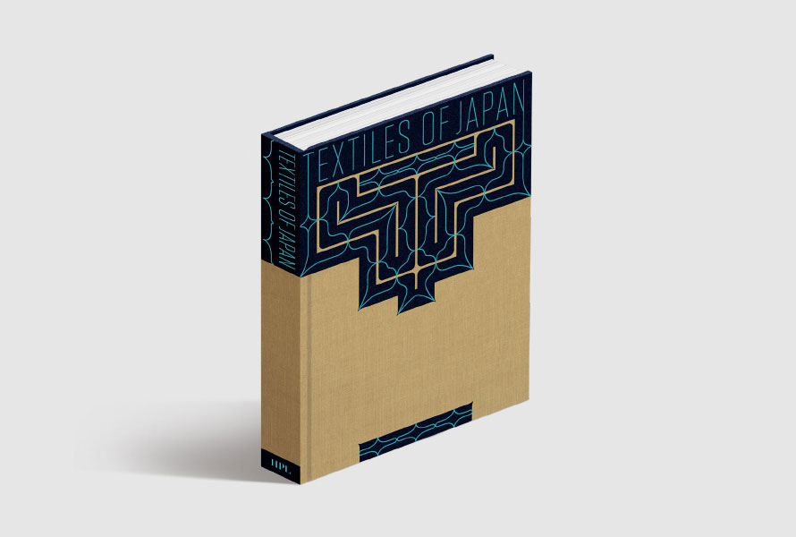 Textiles of Japan book cover with a bold geometric navy block pattern on sand-coloured material