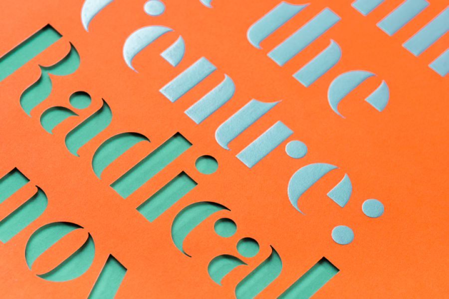 Embossed and die-cut stencil type in orange, silver and turcoise